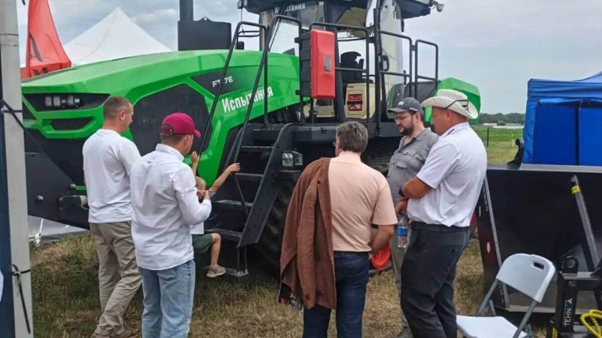 Hybrid FT7E tractor with a group of people gathered around it