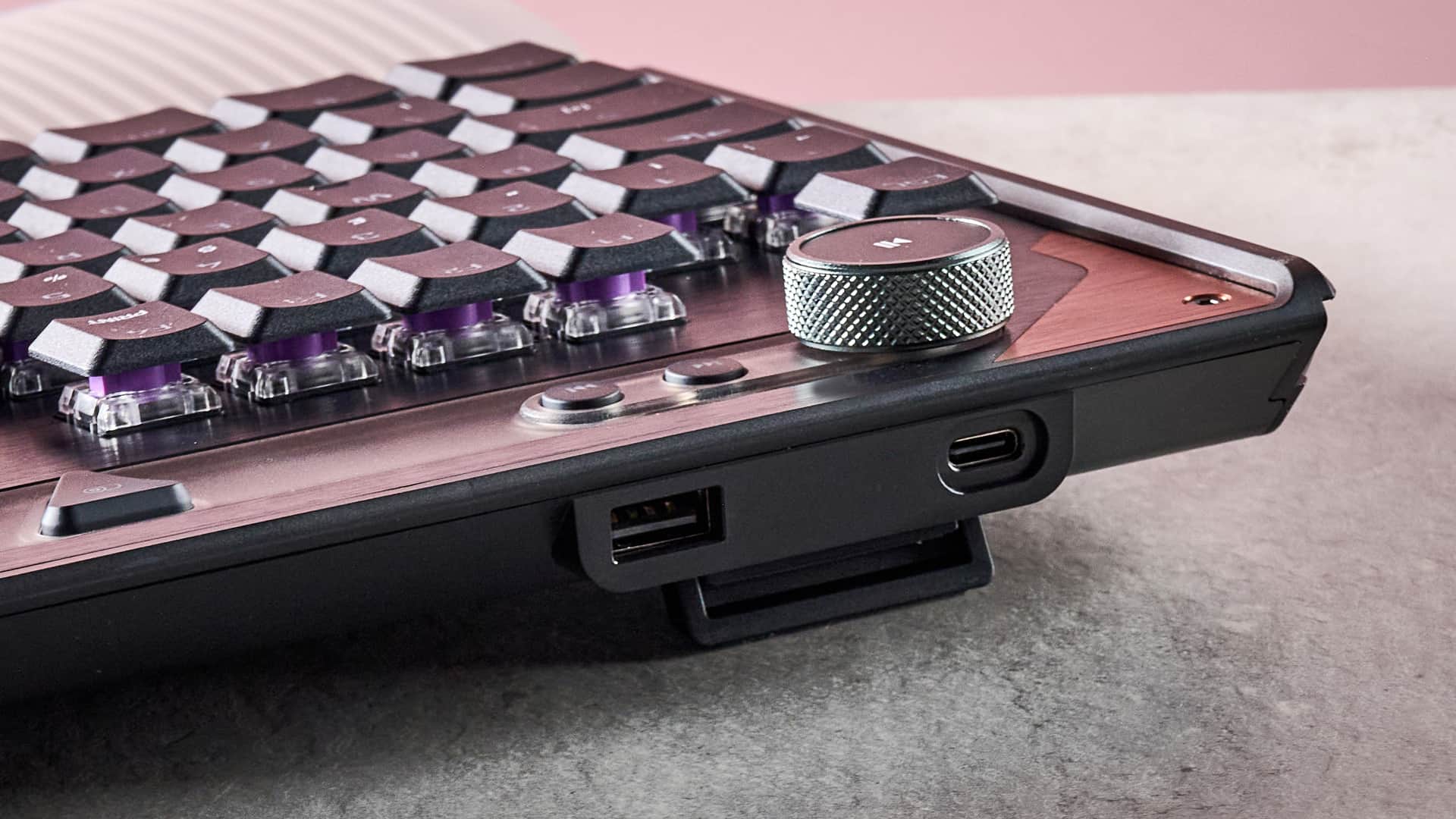 A closeup of the rear corner of the Turtle Beach Command Series KB7, showing its volume knob, media buttons and USB ports.