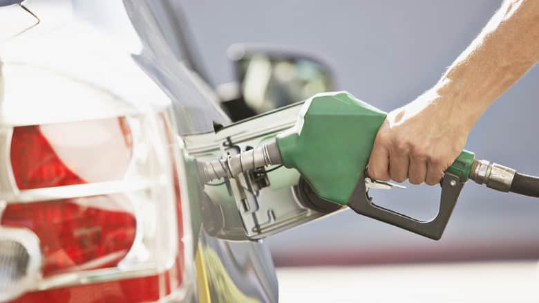 A person fueling up a car