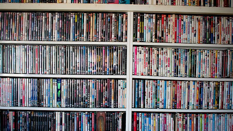 A shelf filled with colorful Blu-rays and DVDs.