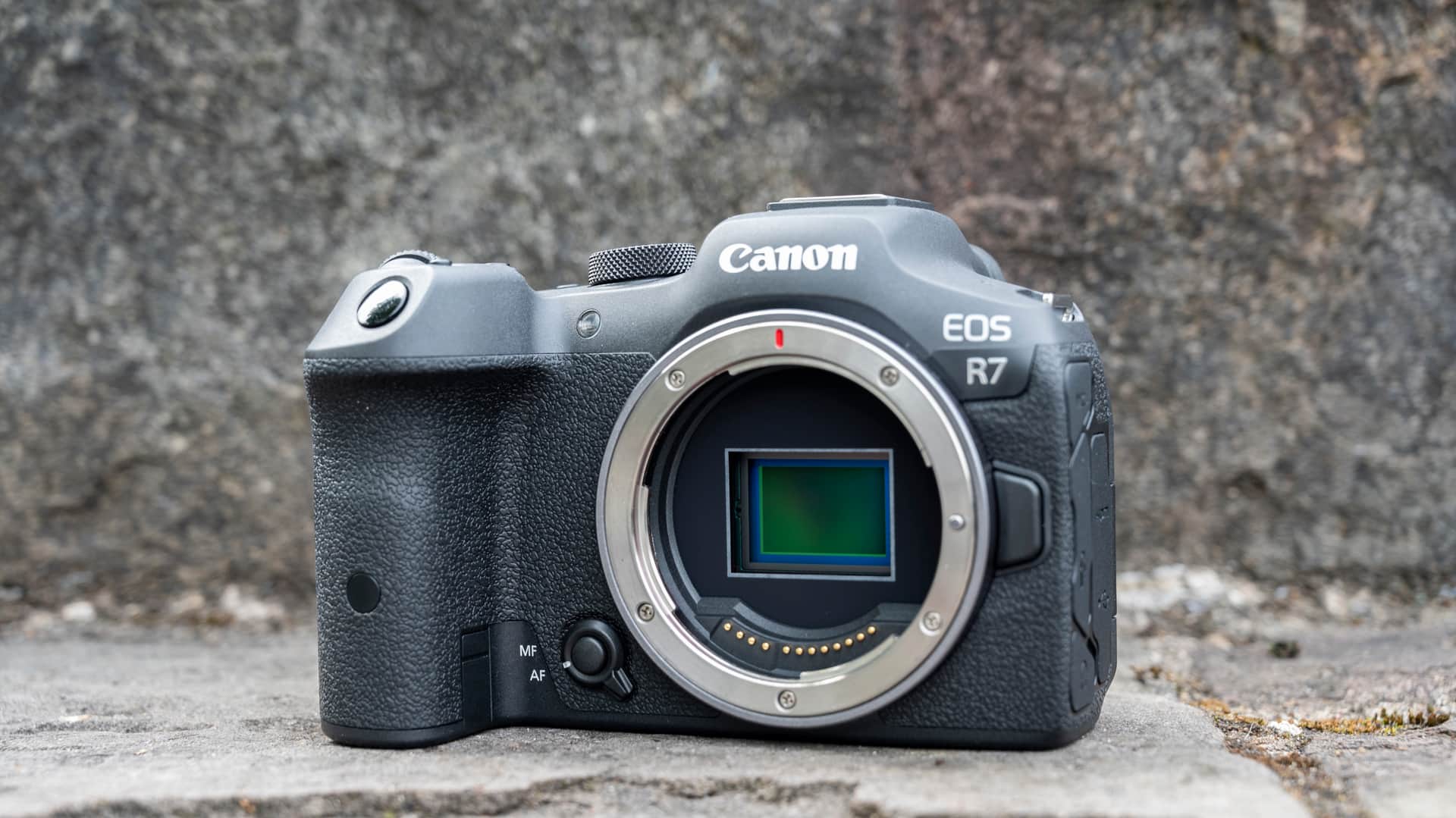 Canon EOS R7 camera sitting on a stone step