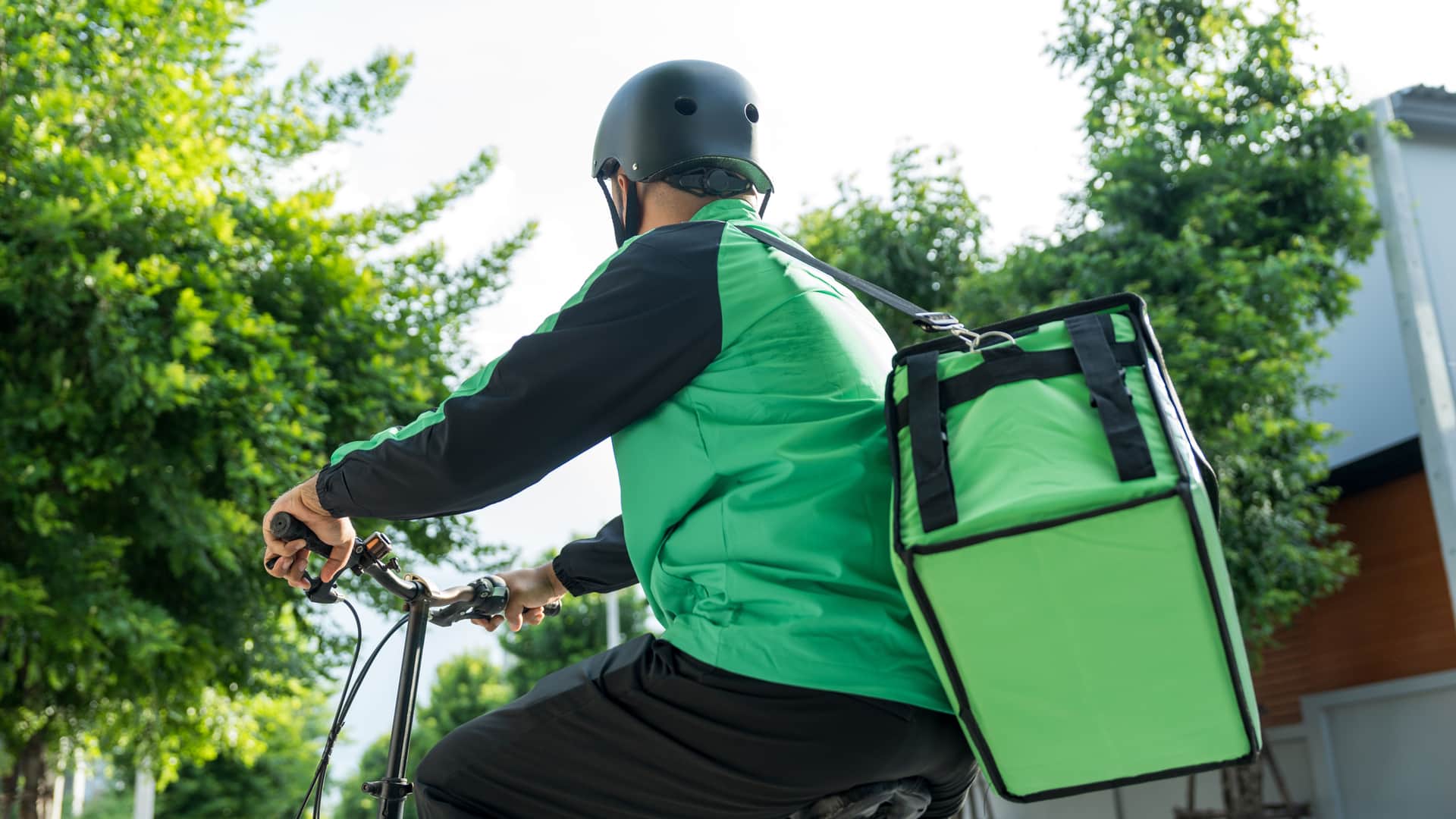 A man on a bicycle delivering food.