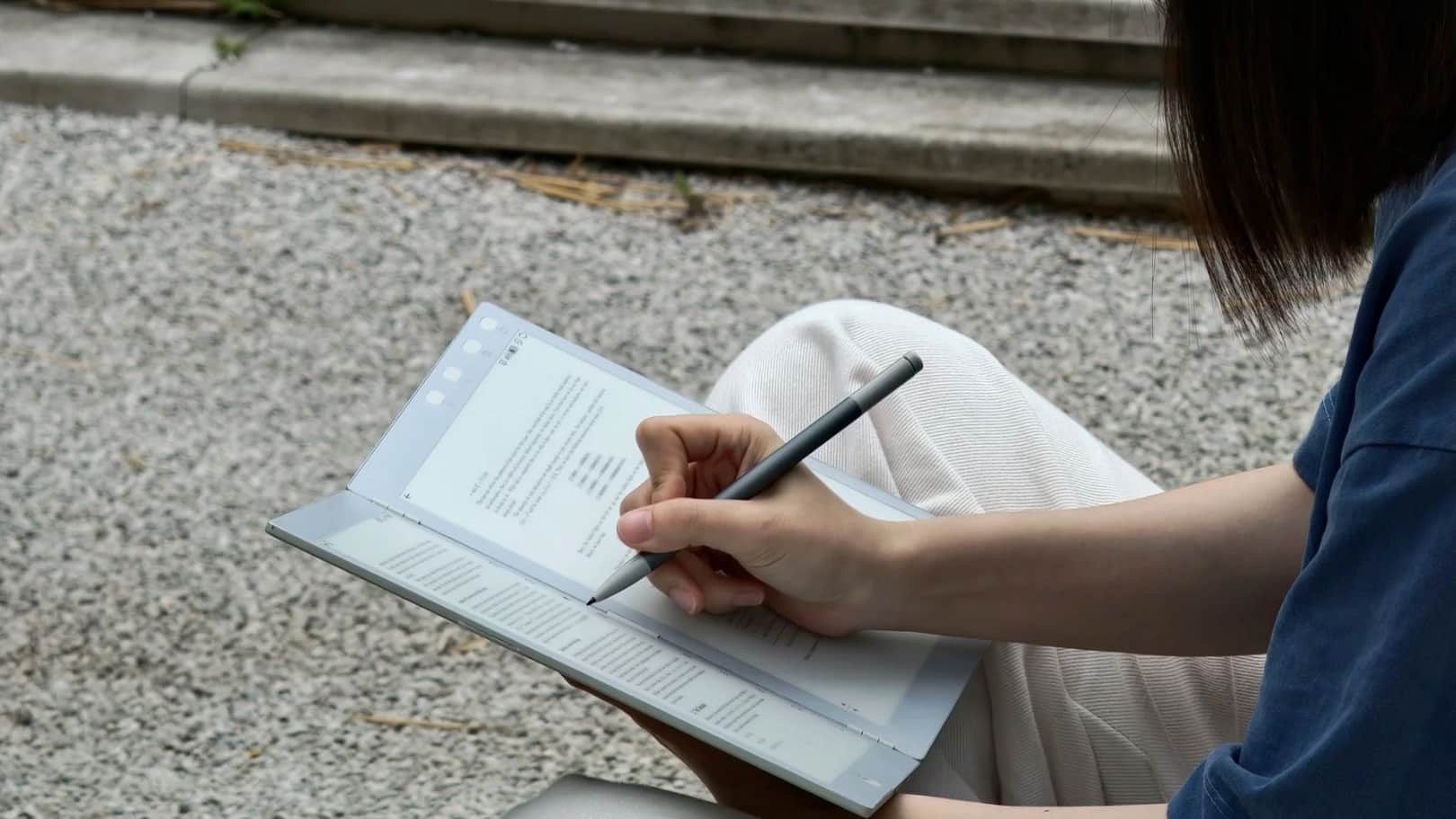 A woman taking notes on the InkLeaf