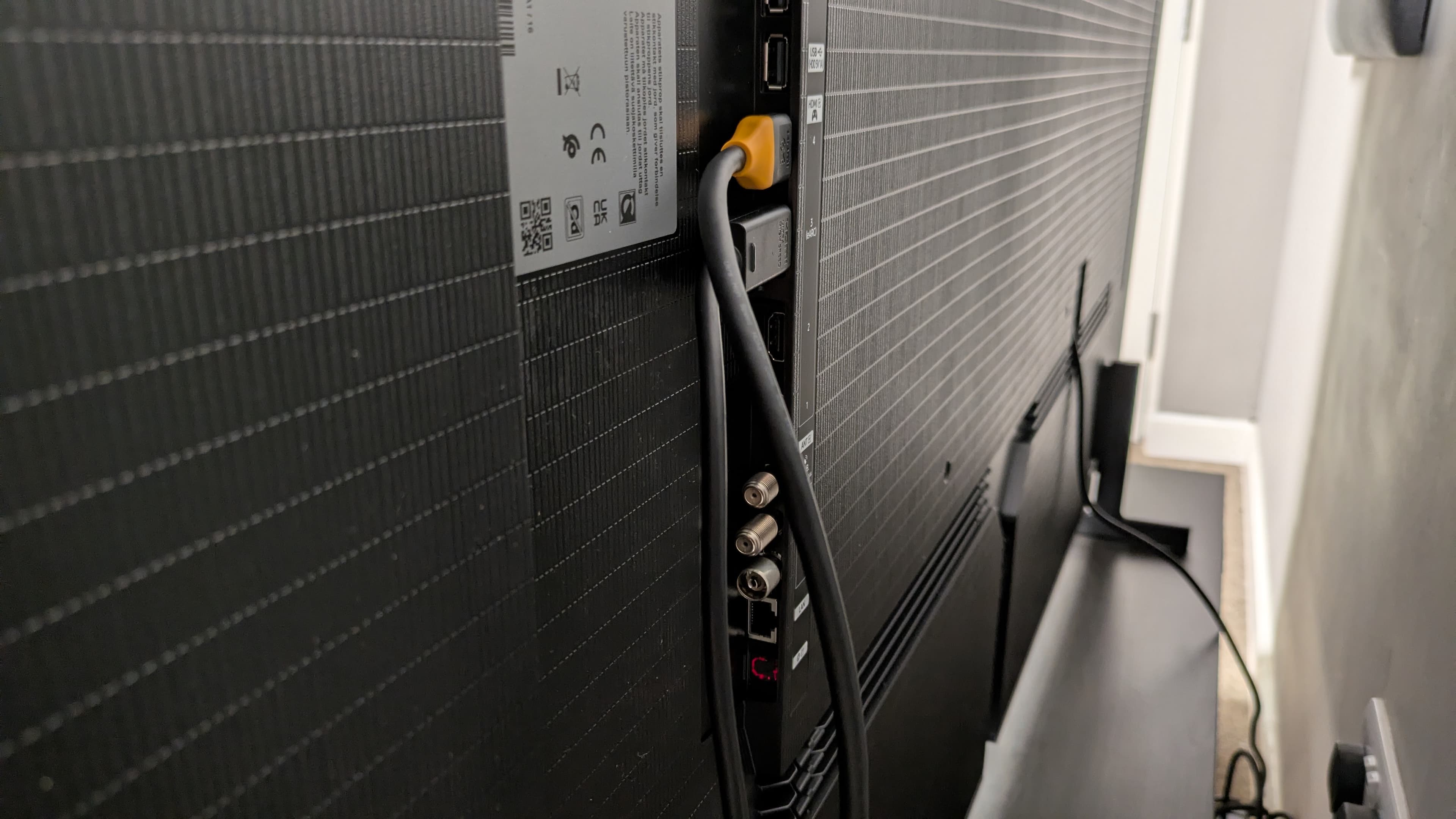 Samsung S95H rear ports with two HDMI cables connected