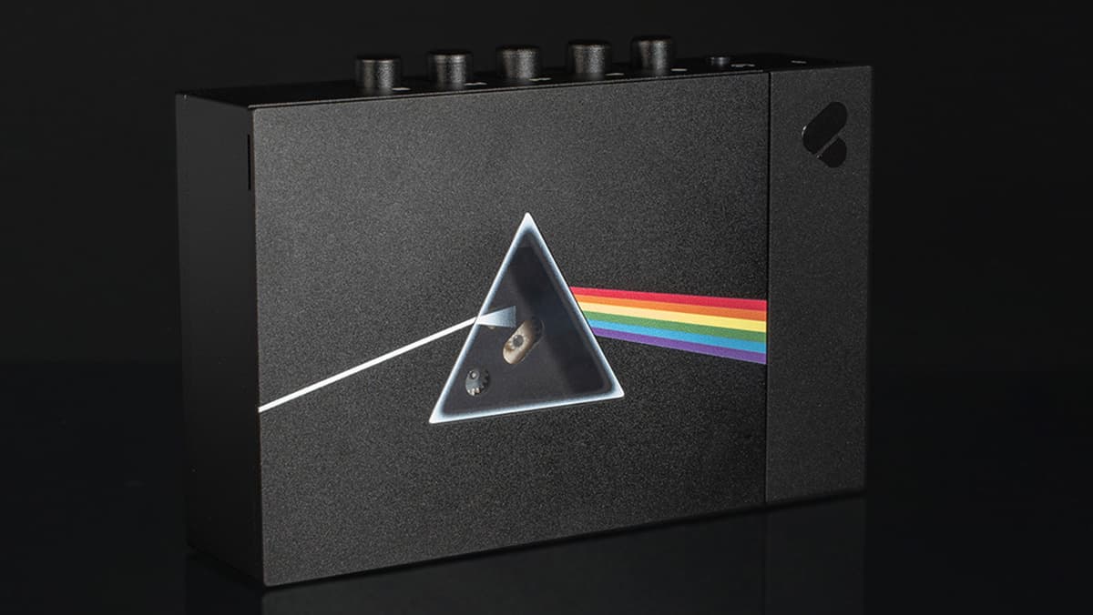 The Pink Floyd x We Are Rewind cassette player showing the Dark Side of the Moon album logo on the front, with a triangular window where the prism would be