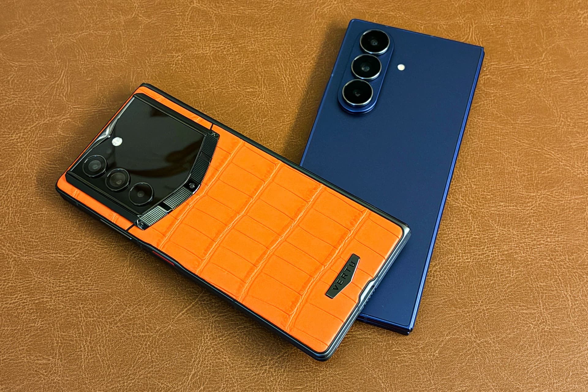 Vertu’s Alphafold with a calfskin leather back and Samsung’s Galaxy Z Fold 7 with a glass back