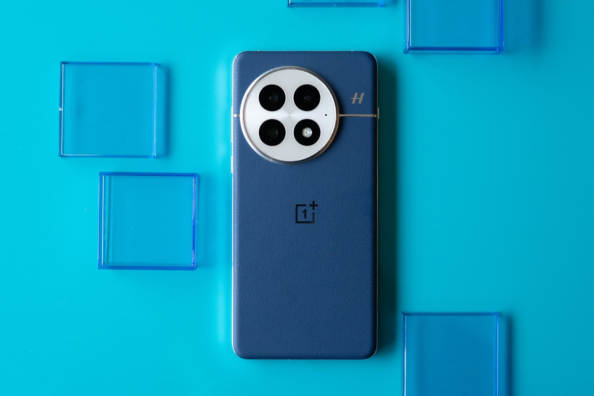 The OnePlus 13 in blue with a vegan leather back panel.