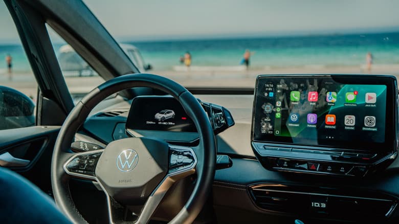Android Auto on the car's entertainment center with the beach visible through the windshield