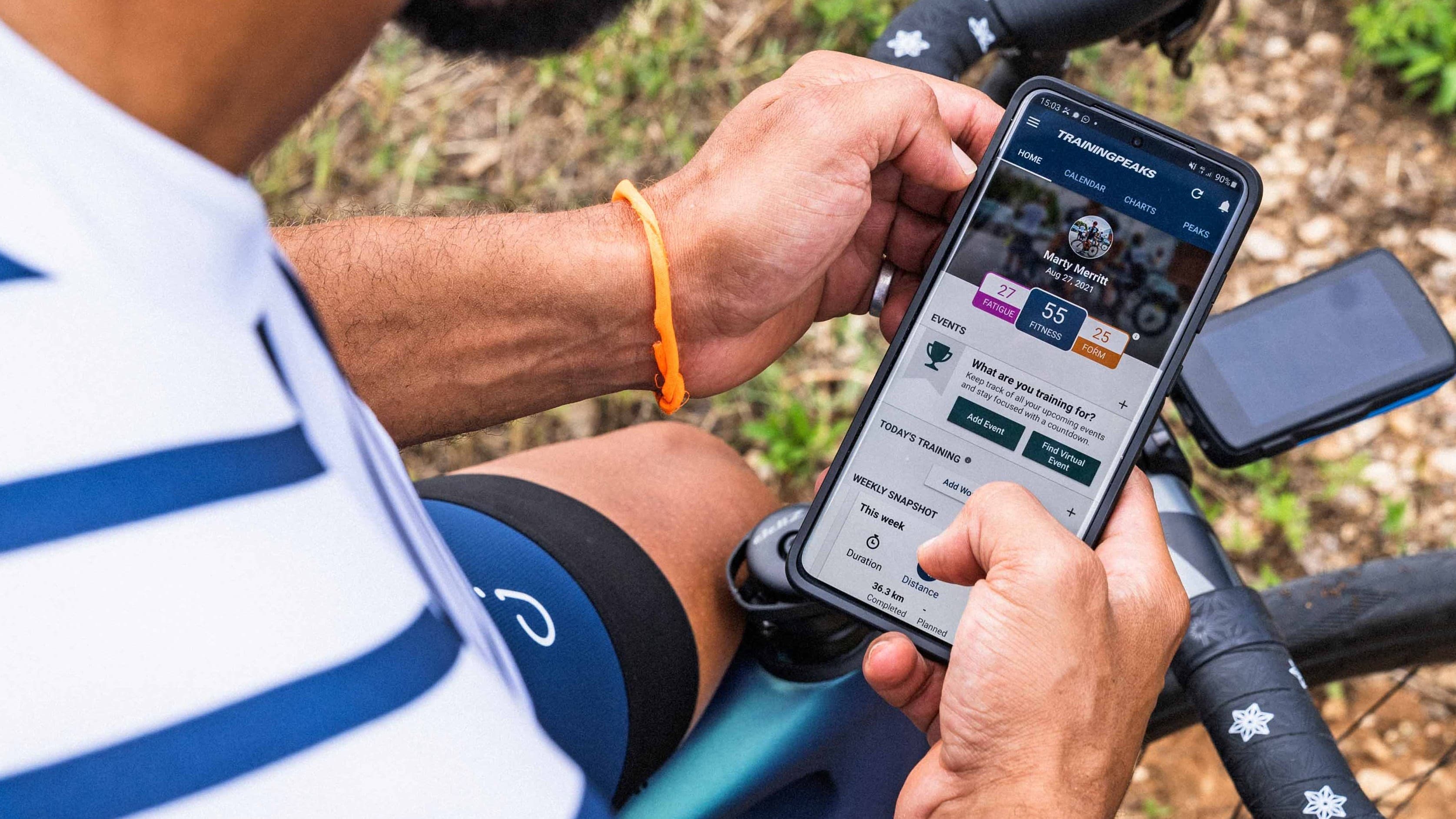 A man using the TrainingPeaks app on a smartphone