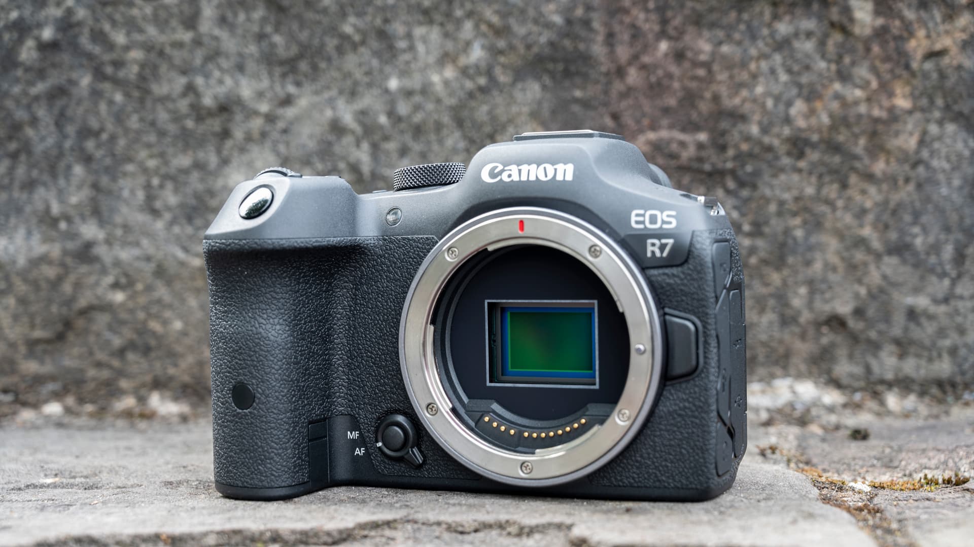 Canon EOS R7 camera sitting on a stone step