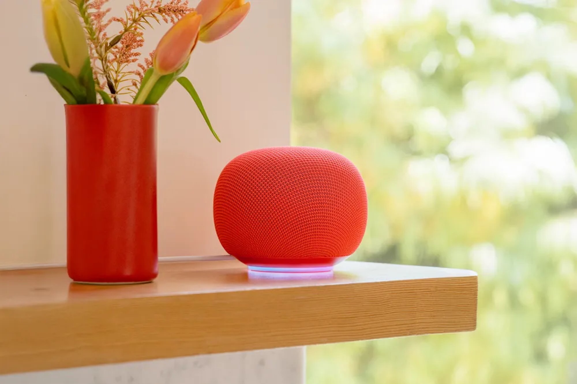The Google Home Speaker sits on a shelf.