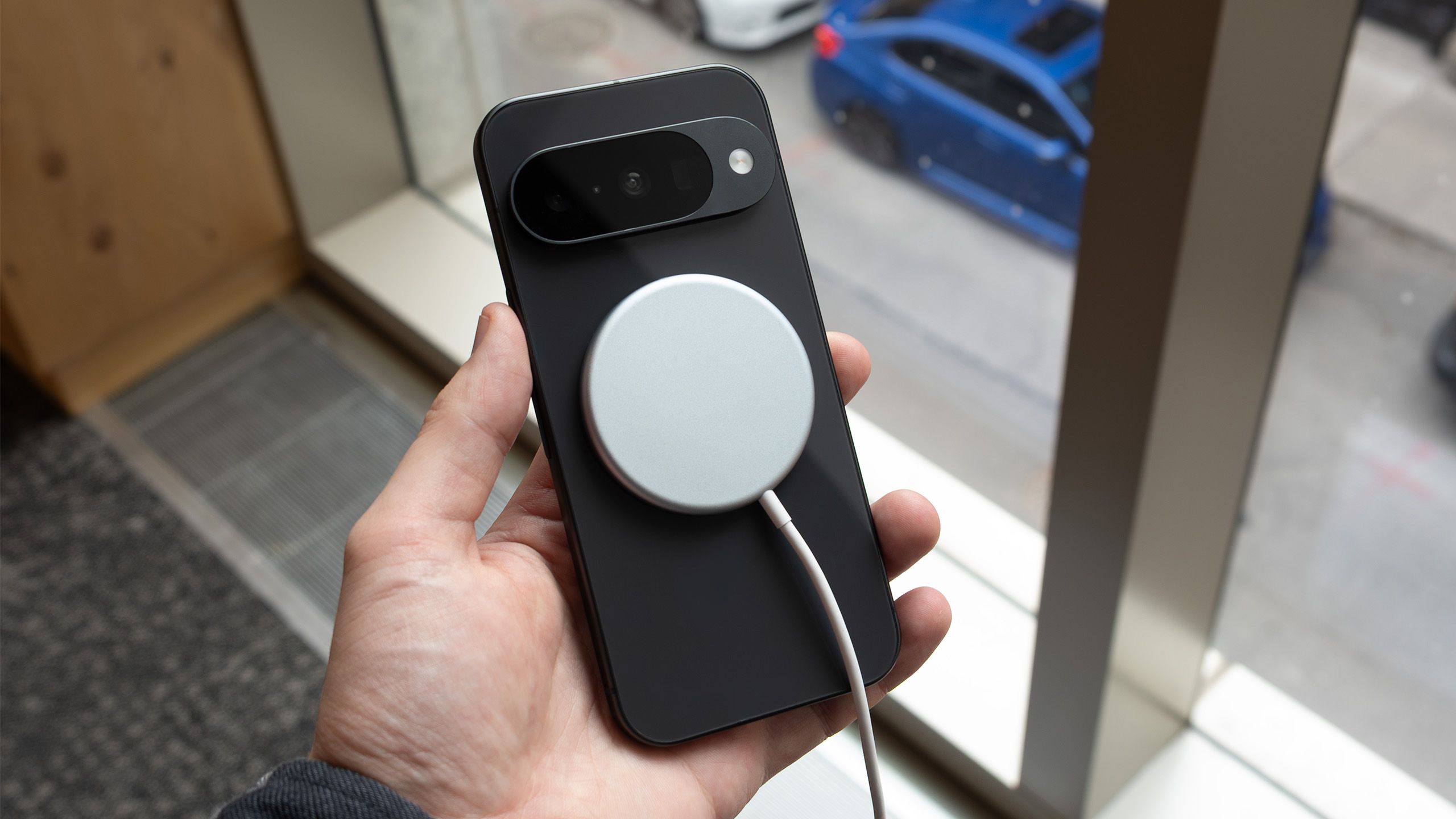 The Pixel 10 with a PixelSnap charger on it