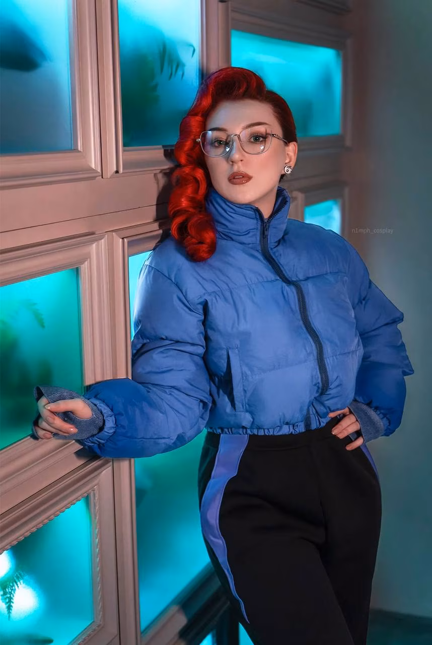 Model cosplaying Anastasia Nazarova in blue jacket and glasses from Atomic Heart