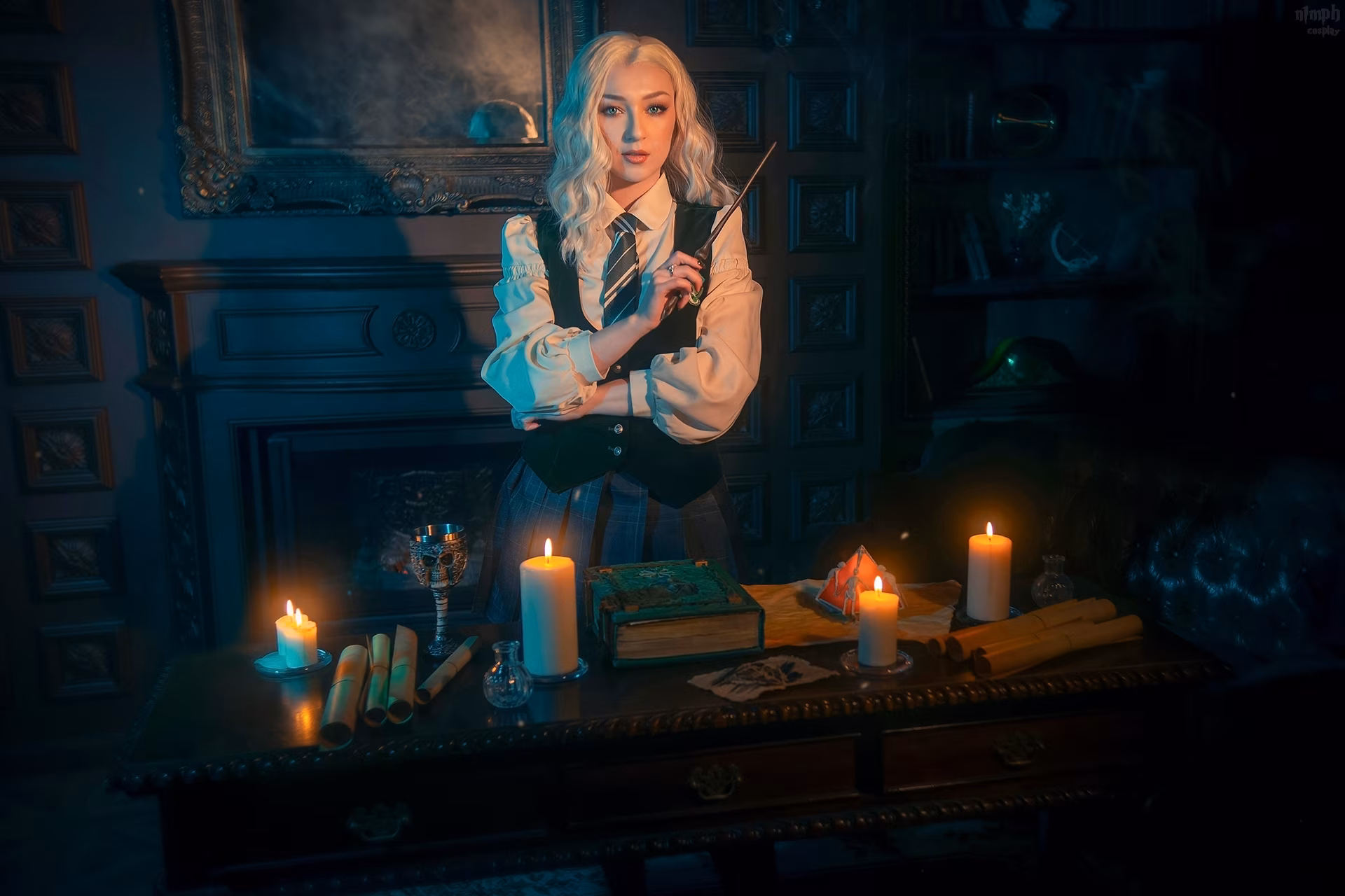 Model with long blond hair in school uniform holding wand by window