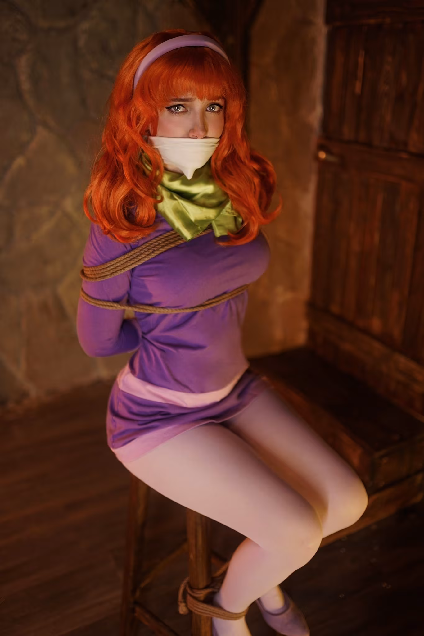 Ulichan as Daphne sitting on a stool