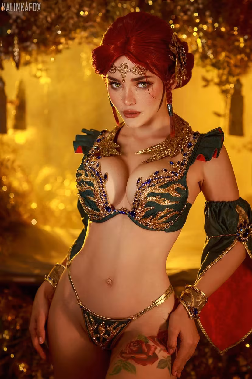 Triss cosplay in revealing green and gold outfit with thigh tattoo