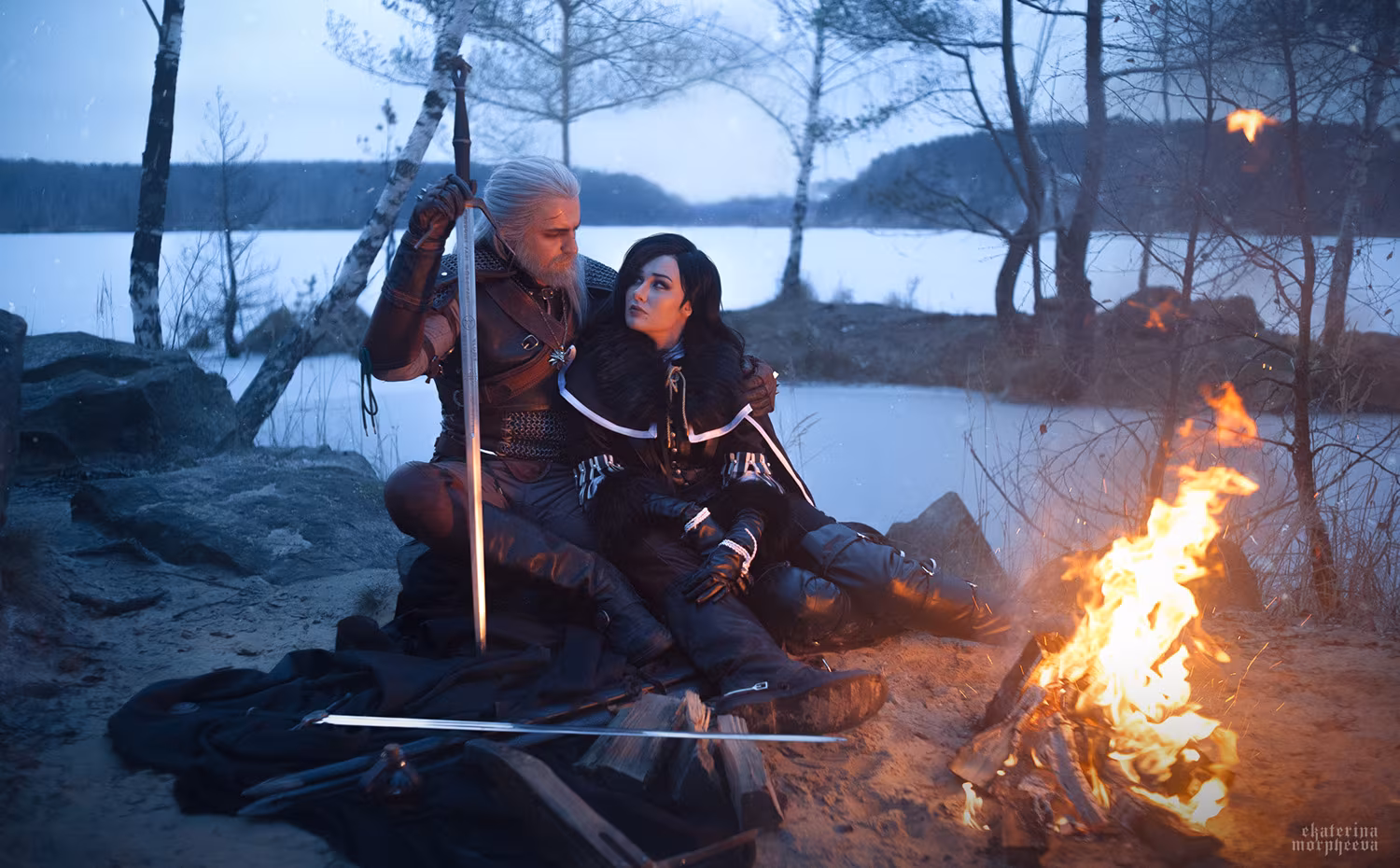 Two characters by campfire in traveling clothes