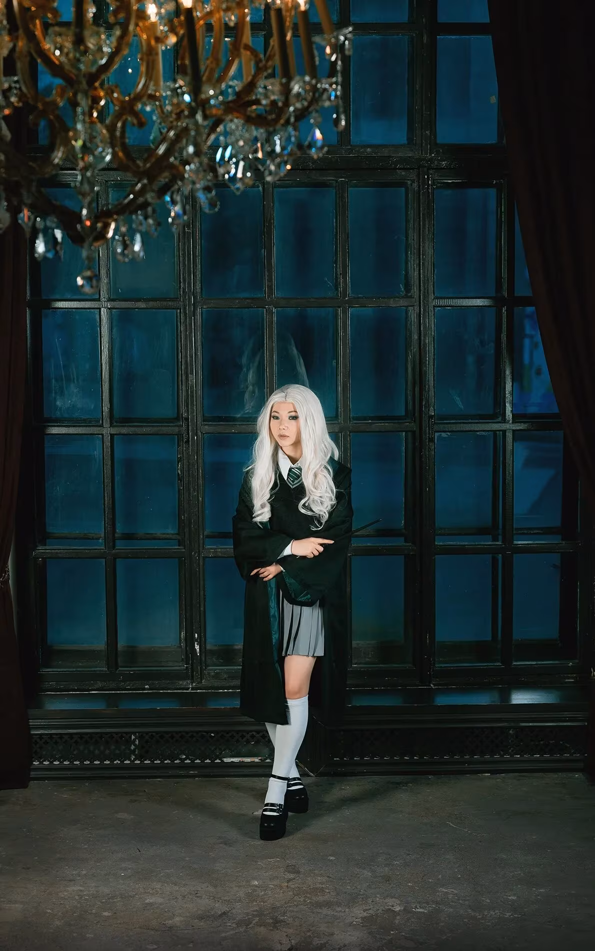 Girl in cosplay school uniform combining Slytherin and Ravenclaw styles
