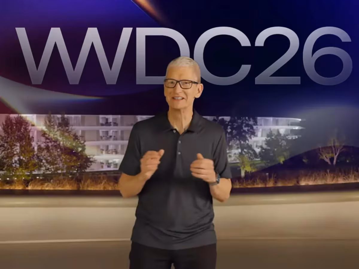 Man standing on stage in front of WWDC 26 backdrop