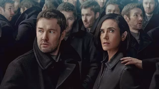 Two people in black clothes in crowd on Apple TV