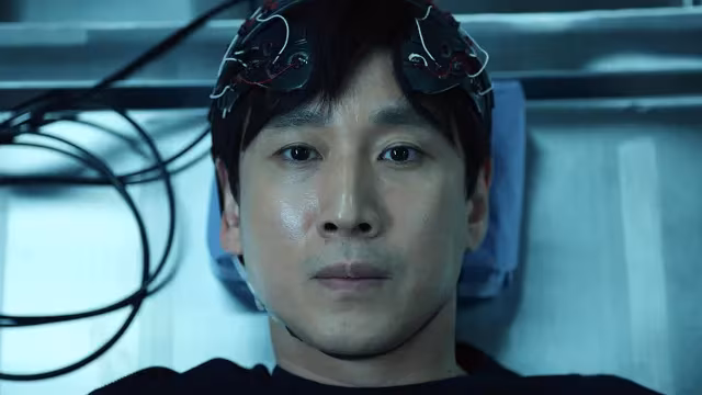Person in futuristic lab surrounded by tech devices from Apple TV series