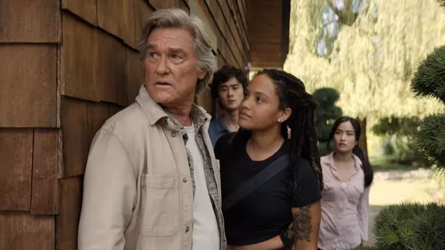 Scene from Apple TV series with people near a wall