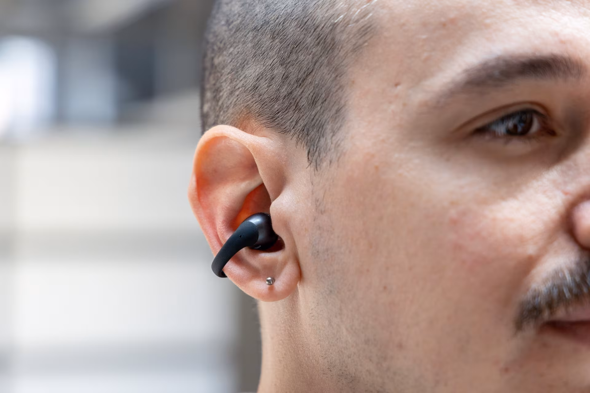 Person listening with Shokz OpenDots 2 headphones