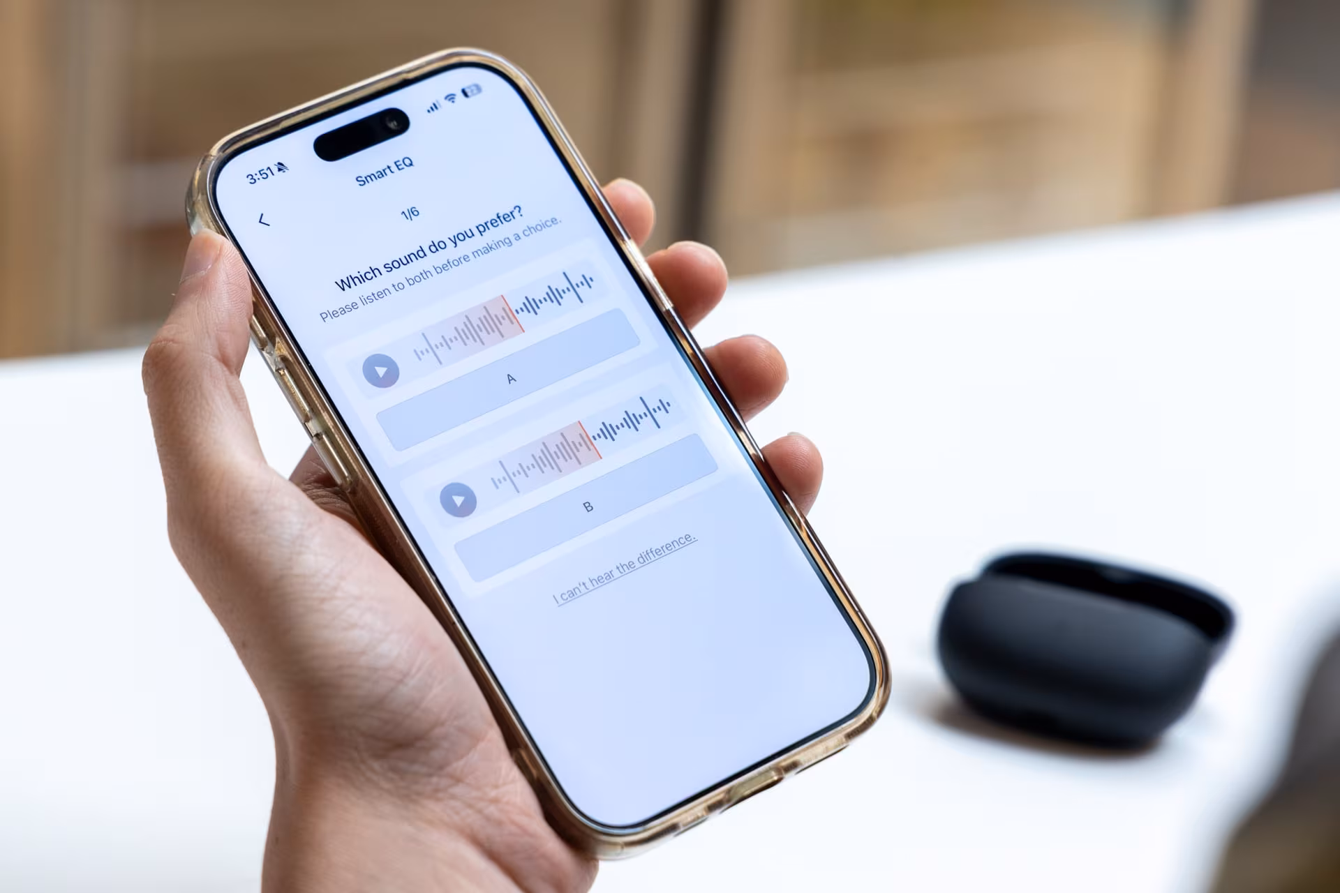 Person holding iPhone showing Smart EQ app