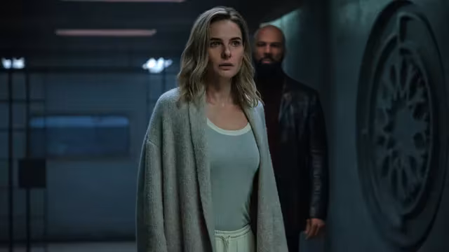 Woman in gray cardigan and white pajamas from sci-fi series on Apple TV