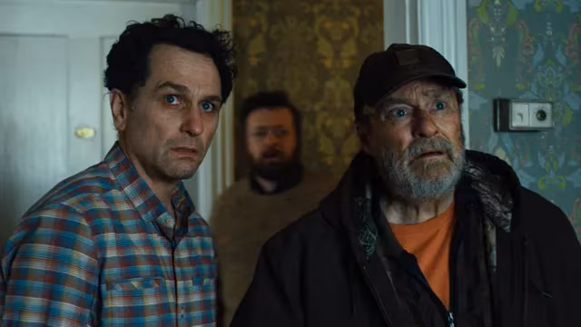 Two men and a man in background from Apple TV sci-fi series